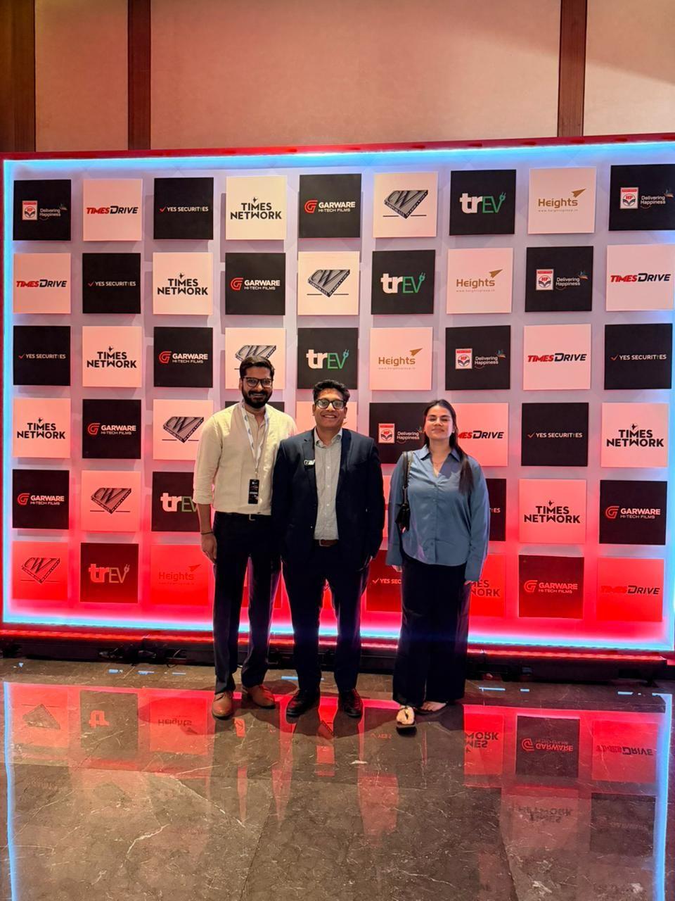 The trEV team at the Times Drive Auto Summit partner wall